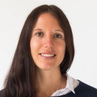 Carina Knorz - Management Assistant: Smiling woman with long, dark brown hair and brown eyes.
